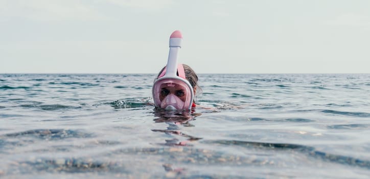 Young happy woman in white bikini put pink snorkeling mask on beach before swimming. girl having fun relaxing on beautiful beach. Beach lifestyle