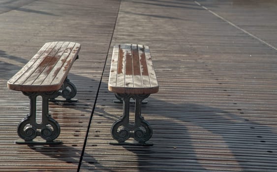 France, Paris - Jan 03, 2024 - Romantic couple wooden benches made to wooden and iron stands on pedestrian bridge at Pont des arts in Paris. Space for text, Selective focus.