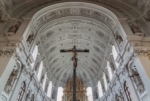 Munich, Germany - Dec 21, 2023 - Jesus hanging on the cross, Crucifix in the interior of St. Michael's Church (Michaelskirche Jesuit church) in Munich pedestrian zone. It is the largest Renaissance church north of the Alps. Space for text, Selective focus.