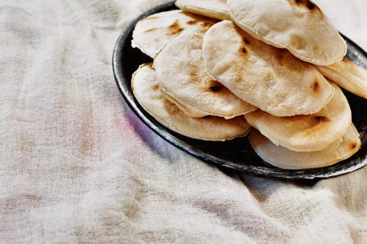 Pita bread  in plate, round flatbread also called Arabic  or Greek bread