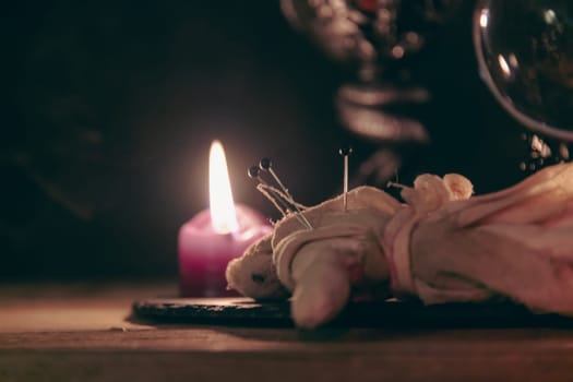 A detailed close-up shot of two lit pink candles with a dark, mystical background, emphasizing a ritualistic theme