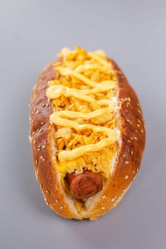 hot dog with sausage and chips with cheese sauce.