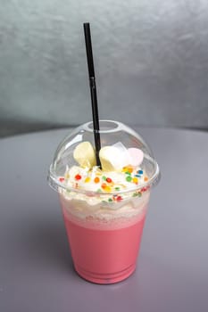 pink pink milky cocktail in a plastic glass.