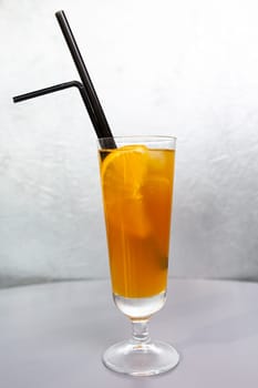 orange cocktail with a slice of orange in a glass glass.