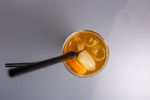 top view orange cocktail with a slice of orange in a glass glass.