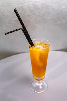 orange cocktail with a slice of orange in a glass glass.