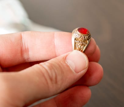 Close up shot of an old, vintage ring with some latin words in it