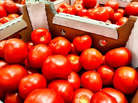 Red ripe tomatoes in cardboard boxes. Fresh Tomatoes Displayed for Sale at a Local Market