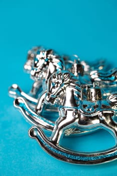 christmas tree toys silver horses on a blue background.