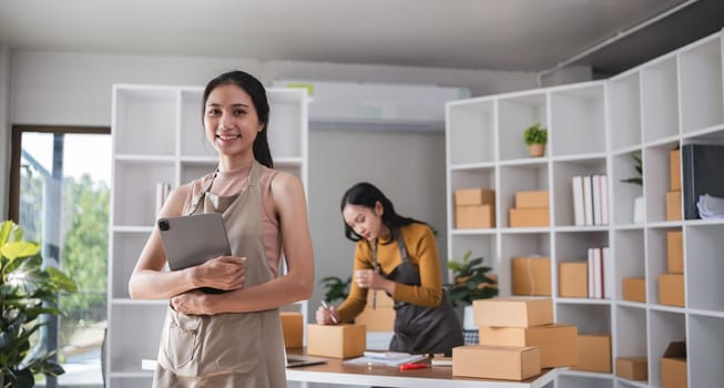 Asian woman working with tablet in online business office.