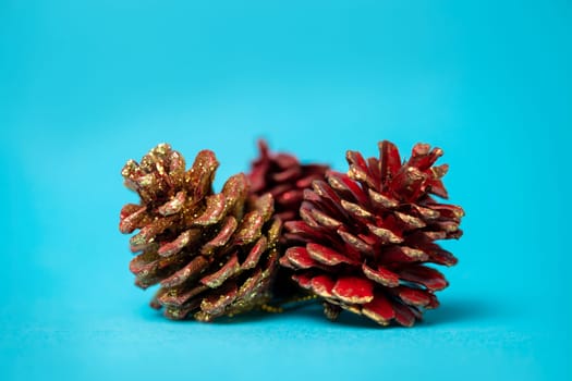 christmas pine cones on a blue background.