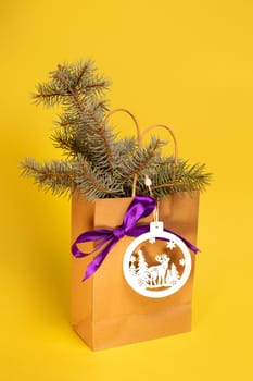 craft package with spruce and Christmas toys on a yellow background.