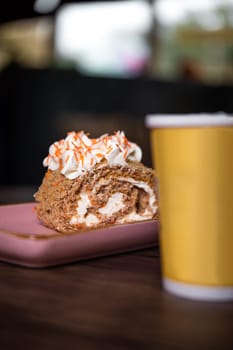 confectionery dessert roll with yellow cup of coffee.