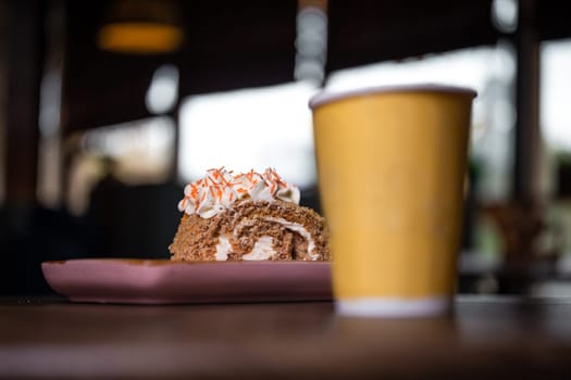 dessert and a cup of coffee on a wooden table in a cafe.