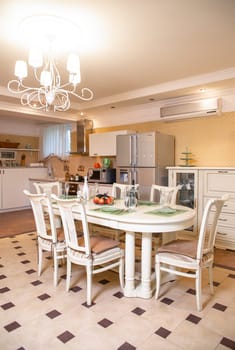 bright kitchen with a dining area. stylish table and chairs in the room.