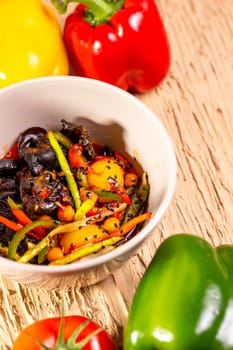 Fresh vegetable salad with tomatoes, peppers, cucumber, carrot, onions, and sesame seeds, a healthy and colorful meal.