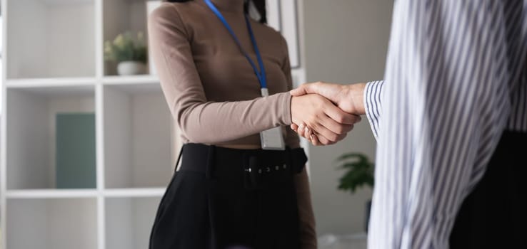 Businessmen shake hands after reaching an agreement to contract a business together..