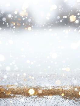 Sparkling gold dust and glitter create a magical winter atmosphere against a soft, snowy backdrop. The festive ambience evokes the spirit of holiday celebrations