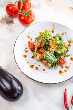 A delicious and healthy salad with grilled vegetables, greens, and tomatoes. Perfect for a light lunch or side dish.