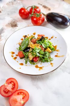 A delicious and healthy salad with grilled vegetables, greens, and tomatoes. Perfect for a light lunch or side dish.