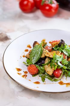 Delicious and healthy vegetable salad with grilled eggplant, spinach, and tomatoes. Perfect for a light lunch or side dish.