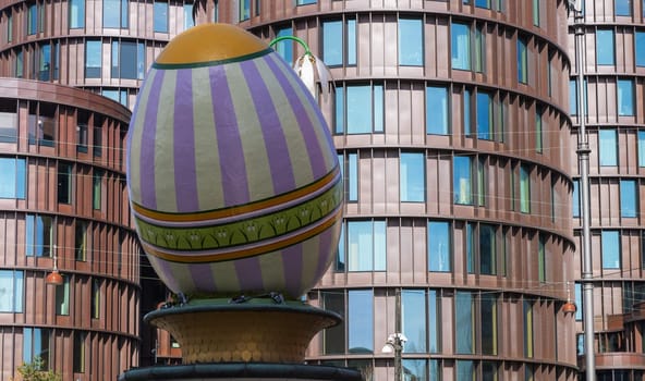 A large decorative Easter egg against a modern building in the city of Copenhagen, Denmark