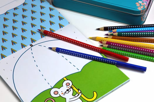 Colored pencils for drawing various colors and coloring book for children. Children's creativity concept.