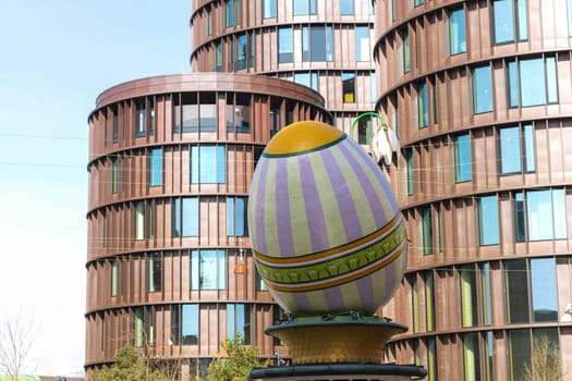 A large decorative Easter egg against a modern building in the city of Copenhagen, Denmark - March 28, 2024
