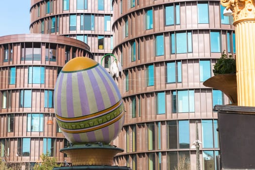 A large decorative Easter egg against a modern building in the city of Copenhagen, Denmark