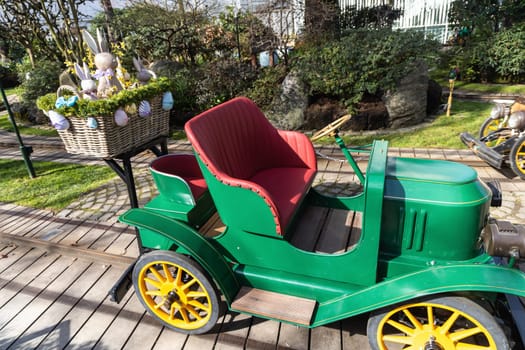 Attraction for children, car in an amusement park decorated with Easter eggs and bunnies. Entertainment for Easter.