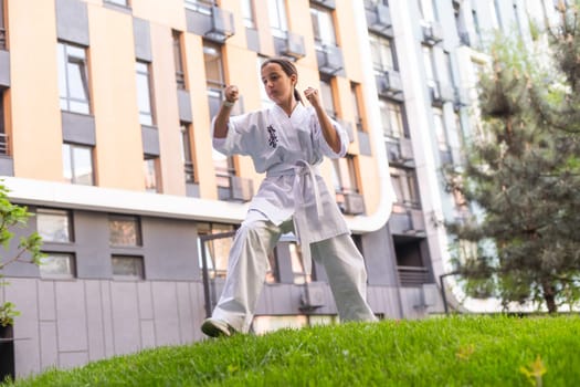 Karate, teenager girl in kimono training. High quality photo