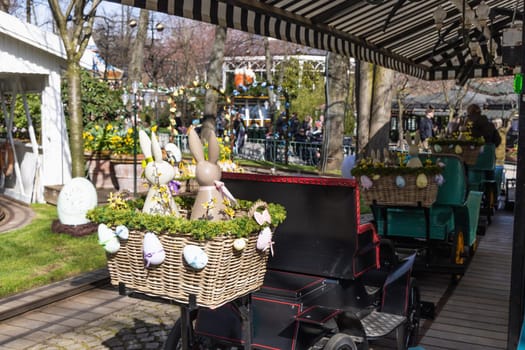 Attraction for children, car in an amusement park decorated with Easter eggs and bunnies. Entertainment for Easter.