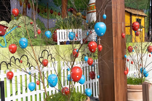 Decorative Easter eggs hanging on tree branches. Easter concept.