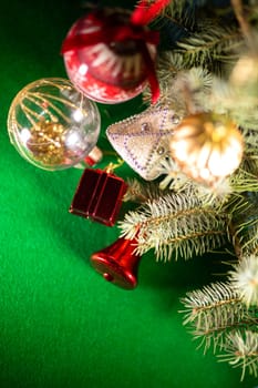 Christmas toys on the Christmas tree on a green background.