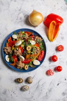 nicoise salad on the table with vegetables top view.