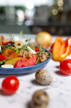 nicoise salad with tuna close-up on the table with vegetables.