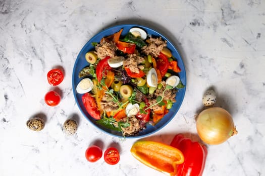nicoise salad on the table with vegetables top view.