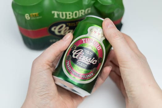 Danish beer in cans Tuborg Classic. The most popular beer. Copenhagen, Denmark - March 4, 2024.