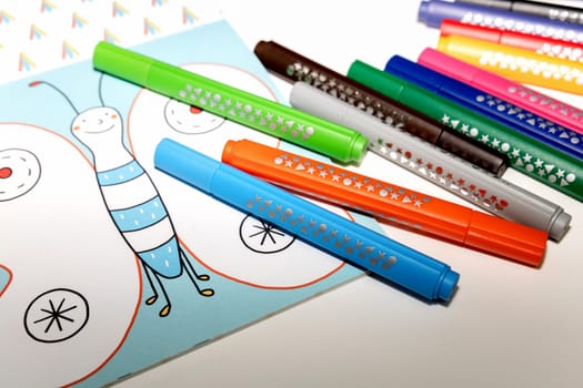 Colored markers for drawing various colors andcoloring book for children. High quality photo