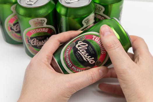 Danish beer in cans Tuborg Classic. The most popular beer. Copenhagen, Denmark - March 4, 2024.