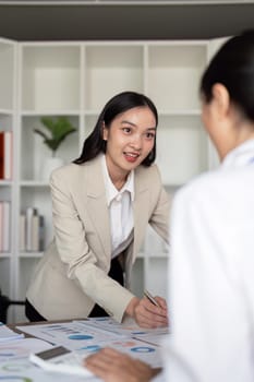 Young businesswoman presenting financial data in a modern office. Concept of leadership, strategy, and professional growth.