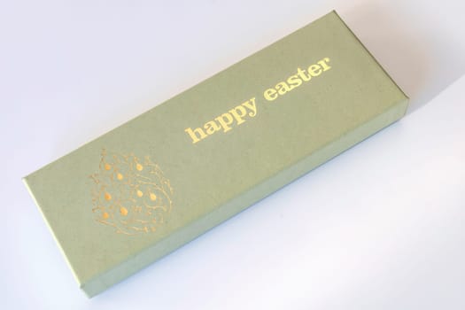 A box of chocolate eggs with the inscription in English Happy Easter. Easter concept.