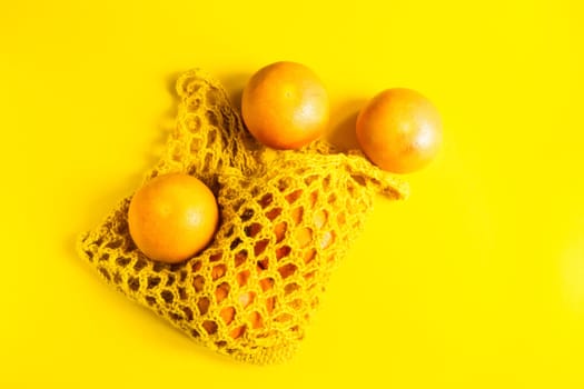 Juicy lemons on a bright yellow background, citrus minimal concept. Flat lay, top view, copy space.