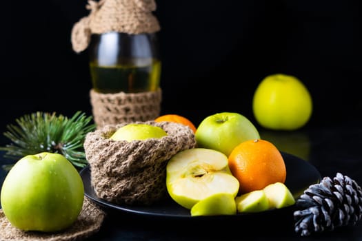 Fresh ripe green apples on a wooden table against dark background, space for text
