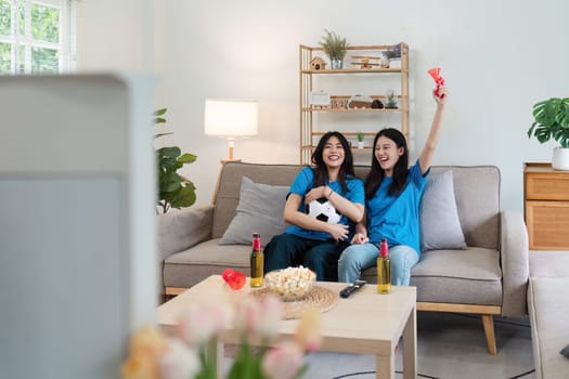 two friends woman enjoying watching football game, happy after team were cheering for win at home. World Cup concept.