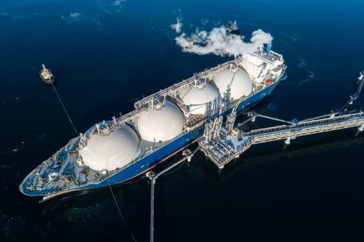 Large lng tanker docked at industrial port terminal for cargo operations