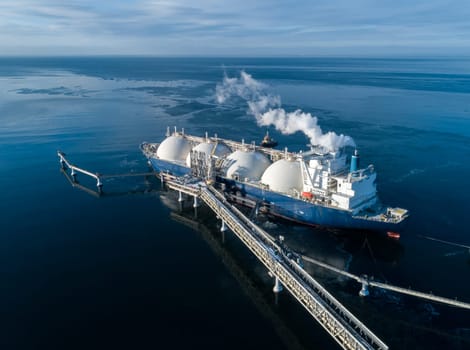 Large lng tanker docked at industrial port terminal for cargo operations