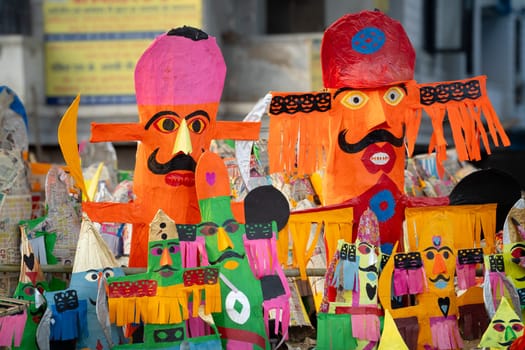 Multiple small colorful paper effigies of demon king ravan burnt on the hindu festival of Dussehra Vijayadashami in India