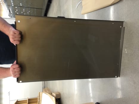Person Holding Store Fixture Panel, Retail Store Set Up. High quality photo