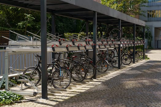 Wroclaw, Poland - August 4, 2023: A group of bicycles neatly parked in a designated parking lot on a sunny day, ready for their riders to return.